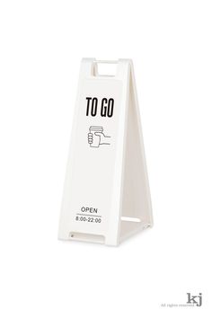 a white sign with the words to go written on it