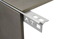 an image of a stainless steel cabinet door hinges on the side of a refrigerator