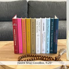 a wooden table topped with books and a tassel on top of each bookcase