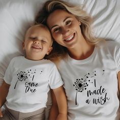 Celebrate the heartwarming bond between a mother and her child with our "I Made a Wish" and "I Came True" Matching Mom & Kid/Baby Shirts. These beautifully designed shirts encapsulate the love and joy that a child brings into a mother's life. Each shirt carries a heartwarming message. The "I Made a Wish" Shirt symbolizes the mother's wish. The "I Came True" shirt symbolizes the child who fulfilled that wish. Both shirts display the same dandelion design. Whether you're gifting this matching set to a new mom, for Mother's Day, or as a heartwarming gesture on any special occasion, these shirts hold a deep and meaningful message. Our t-shirts are a touching reminder of the love shared between mother and child. These shirts are perfect for family photos, special occasions, or just everyday wea Mom And Daughters Tshirts, Mother And Daughter Tshirts, Mommy Daughter Shirts Disney, Mom And Teen Daughter Matching Shirts, Mom And Daughter Shopping Shirts, Mother Daughter Shopping Shirts, Shirt Display, Dandelion Designs, Daughters Shirt