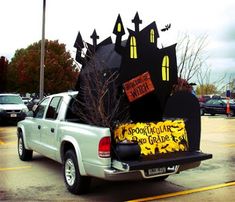 a pick up truck with decorations on the back in a parking lot at halloween time