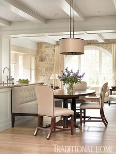 a dining room table and chairs in front of a window