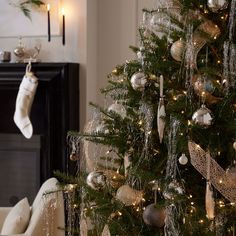 a decorated christmas tree with stockings hanging from it