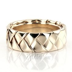 a gold wedding band with an intricate design