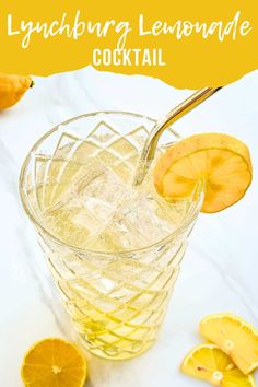 a glass filled with lemonade sitting on top of a white table next to sliced oranges