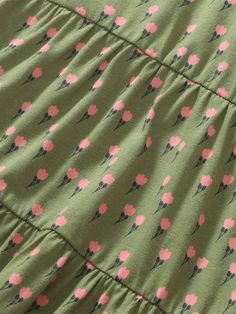 a green dress with pink flowers on it