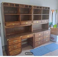 an office desk with drawers and shelves on the floor