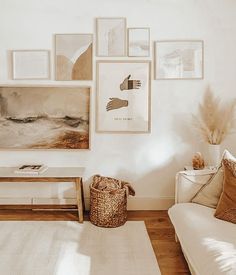 a living room filled with furniture and pictures on the wall