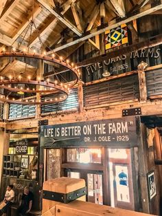 the inside of a building with wooden beams and lights hanging from it's ceiling