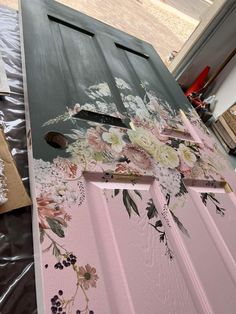 the door is painted pink and has flowers on it