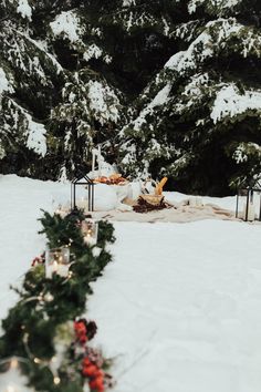 a table with food and candles in the snow