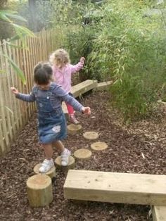 two young children playing in a garden area