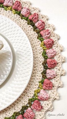 a crocheted doily with a cup and saucer on it