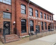 an old red brick building with the words marathon automobile written on it