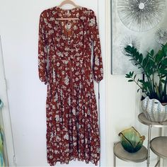 Great Spell Boho Maxi Hi-Low Dress Burnt Ember Floral Print Size Xs. Loaty 3 Tiers Frills From The Waist, Curved V Neckline, Long Sleeve , Elastic Cuff, Hi-Low Maxi Length, Buttons Front, Drawstring Waist, Front And 1/2 Skirt Lined. Great Used Condition, No Notable Flaws. Tags: Boho, Bohemian,Victorian, Event, Special Occasion, Casual. Rust, Cream And Black Floral Print. Chest: 17" Length: Front Lenght 36'', Back 38'' Sleeve 23'' Waist: Drawstring Waist 15'' Shoulders 14'' All Measurements Appro Long Sleeve Ditsy Floral Maxi Dress For Garden Party, Fall Flowy Maxi Dress With Ditsy Floral Print, Fall Ditsy Floral Print Maxi Dress, Brown Boho Long Sleeve Dress For Spring, Brown Long Sleeve Boho Dress For Spring, Long Brown Dress With Floral Print, Long Brown Floral Print Dress, Boho Print Long Sleeve Maxi Dress For Brunch, Bohemian Ditsy Floral Print Daywear Dresses