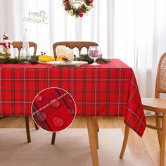 a christmas table setting with red and green plaid cloth