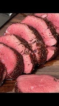 sliced steak on a cutting board with knife