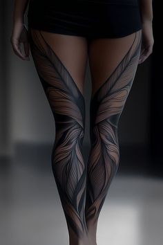 a woman's legs with tattoos on them