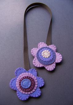 two purple and blue flowers on a brown cord