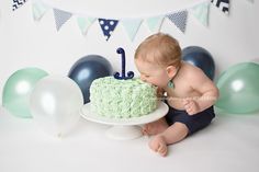 a baby is sitting in front of a cake