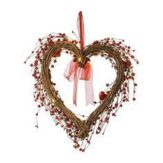 a heart shaped wreath with red berries hanging from it's side on a white background