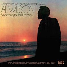 an album cover with a man standing in front of the ocean and sunset behind him