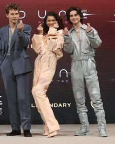 three actors posing for the camera at an event