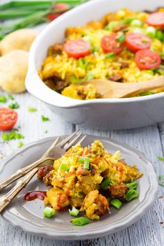 an egg casserole with tomatoes and green beans in a white dish on a gray plate