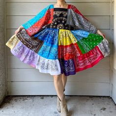 a woman standing in front of a garage wearing a colorful dress