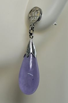 "These are lovely Lavender Jade Drop Earrings in 925 Sterling Silver See our full collection of Vintage Jade: https://www.etsy.com/shop/EastVillageBangles?section_id=38654118 Jade, a birthstone of August, is often the gemstone associated with the twelfth wedding anniversary.  Jade comes in Nephrite and Jadeite varieties, each a crystallized form of silica. Jade draws its name from the Latin ilia, meaning 'flanks, kidney area' giving rise to the informal \"loinstone\".  Jade is known as a symbol of good luck, longevity, and wisdom promoting self acceptance and love. Jade brings a restoring energy balancing Heart chakra.   Jade is a relatively hard stone rating 6.5 on the Mohs scale.  Jade can be cleaned with mild soap in warm water, and a soft toothbrush or cloth.  Avoid harsh cleansers, bl Formal Lavender Gemstone Earrings, Elegant Lavender Sterling Silver Earrings, Lavender Dangle Earrings For Formal Occasion, Lavender Drop Earrings For Formal Occasions, Elegant Nickel-free Lavender Earrings, Elegant Lavender Nickel-free Earrings, Lavender Dangle Jewelry For Formal Occasions, Lavender Drop Gemstone Earrings, Elegant Purple Dangle Clip-on Earrings