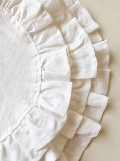 the white ruffles are on top of the table cloth