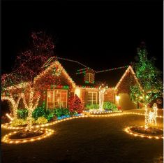 christmas lights decorate the front yard of a house