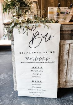 a sign that says the bar and is decorated with greenery on top of it