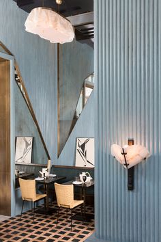 the interior of a restaurant with blue walls and black and white checkered flooring