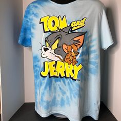 New With Tags Tom And Jerry Tie Dye Tee Shirt Color: Blue/Gray Size: Men’s Large Blue Fan Merchandise T-shirt For Summer, Blue Summer Fan Merchandise T-shirt, Casual Blue Shirt With Letter Print, Blue Pre-shrunk Shirt For Fan Merchandise, Blue Shirt With Letter Print For Fan Merchandise, Blue Shirt With Screen Print For Fan Merchandise, Casual Blue Screen Print Top, Casual Blue Top With Screen Print, Blue Short Sleeve Shirt For Fan Merchandise