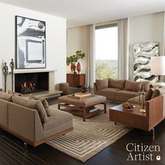 a living room filled with furniture and a fire place under a painting on the wall