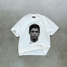 Classic Iconic Football Legend T-Shirt - Limited Edition Show off your passion for football with this bold, minimalist white t-shirt featuring a stunning portrait of one of the game's greatest of all time (GOAT). Designed for fans who admire both style and the unstoppable spirit of football greatness, this tee is perfect for everyday wear--whether you're hitting the gym, watching a match, or just hanging out. Premium quality: Soft, breathable cotton blend for ultimate comfort. Striking design: M White T-shirt With Football Season Screen Print, White Screen Print T-shirt For Football Season, White Streetwear Tops For Football Season, White Streetwear T-shirt For Football Season, White Tops For Football Season Streetwear, White T-shirt For Football Season Streetwear, White Casual T-shirt For Football Season, Casual White T-shirt For Football Season, White T-shirt For Football Season Fan Merchandise