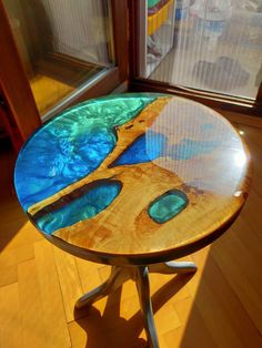 a table made out of wood and glass with a lake in the middle on it