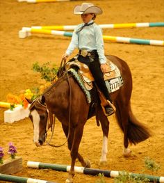 a woman riding on the back of a brown horse