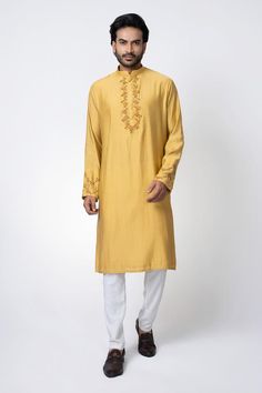 Mustard yellow straight kurta with zardosi hand embroidery. Paired with an off white pyjama.
Components: 2
Pattern: Embroidered
Neckline: Band collar
Sleeve Type: Long
Fabric: Cotton Silk
Color: Yellow
Occasion: Mehendi and Puja - Aza Fashions Yellow Churidar With Dabka For Diwali, Yellow Straight Kurta For Diwali, Yellow Straight Kurta Churidar With Dabka, Gold Chanderi Kurta With Dabka Embroidery, Yellow Churidar With Dabka Straight Kurta, Yellow Dabka Straight Kurta Churidar, Yellow Semi-stitched Traditional Wear With Dabka, Yellow Dabka Kurta For Eid, Traditional Churidar With Gold Embroidery For Festivals