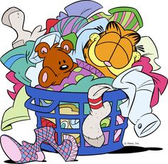 two teddy bears in a basket full of clothes