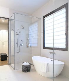 an image of a bathroom with white walls and tub in the corner walk in shower