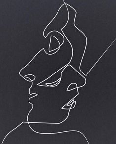 a black and white line drawing of a man's face on a dark background