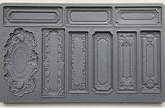 the mold is made to look like it has been carved into an ornate frame and scrolls