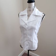 Never Worn Small Sleeveless Button Up Top. White, Semi Sheer. Great Business Attire Or Under Blazer. Small *All Items Sold From My Closet Are Video Taped Prior To Shipment To Show Quality And Cleanliness.* Fitted Summer Vest With Buttons, Elegant Sleeveless Button Blouse, Fitted Cotton Tank Top With Buttons, White Buttoned Tank Top For Work, Classic Sleeveless Summer Vest, Fitted Sleeveless Vest With Buttons, White Sleeveless Top With Buttons, Sleeveless White Blouse With Buttons, White Sleeveless Blouse With Buttons