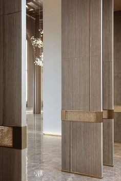 the interior of a modern building with marble floors and gold trimmings on the doors