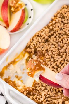 an apple and oatmeal dessert in a white dish