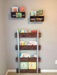 some bookshelves made out of pallets and wooden crates for children's books