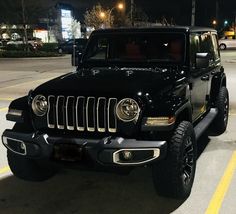 a black jeep is parked in the parking lot