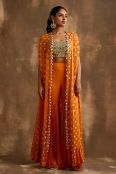 Shop for these amazing collections of Orange Georgette Embroidered Mirrorwork Floral Pattern Gharara Set For Women by Niamh By Kriti online at Aza Fashions. Orange Indian Lehenga, Orange Indo Western Outfits, Cape Indian Outfit, Indian Cape Outfits, Orange Traditional Outfits, Indo Western Sangeet Outfit For Women, Orange Haldi Outfit, Haldi Indowestern Outfit, Indian Haldi Outfit